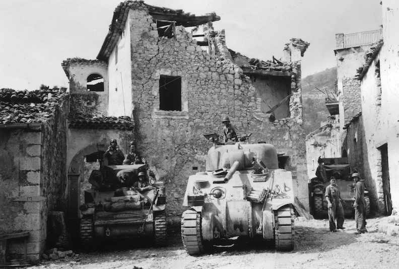 <p class='eng'>Light and medium tanks of 755th Tank Battalion, in Coreno, one hour after its fall, await word to continue advance. Fifth Army, Coreno area, Italy. 14 May 1944 (5/14/1944). National Archives and Records Administration, College Park, Maryland (111-SC-190082)</p>
